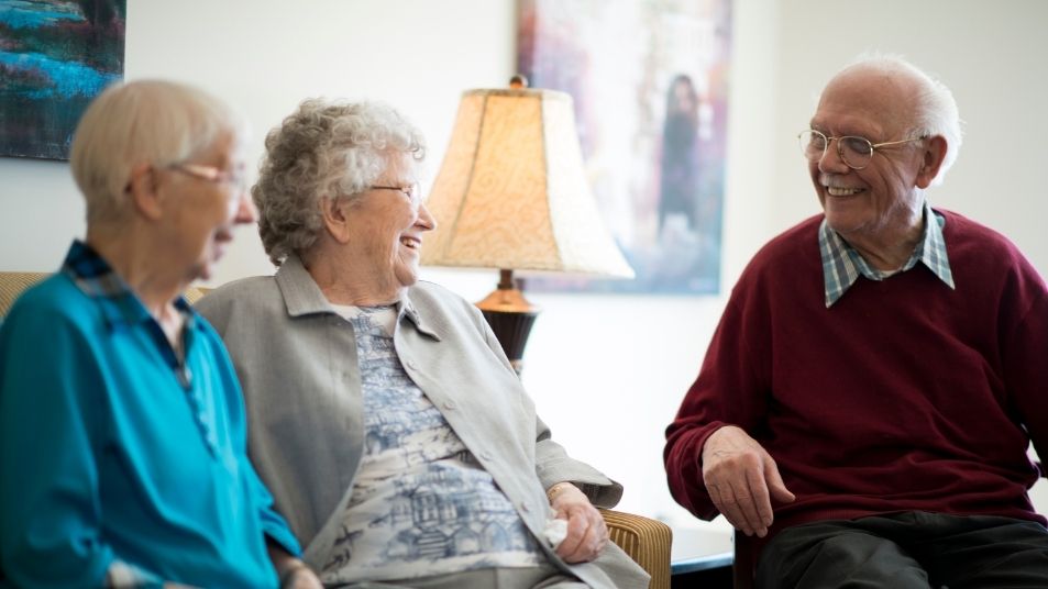 Photo of three elderly people smiling